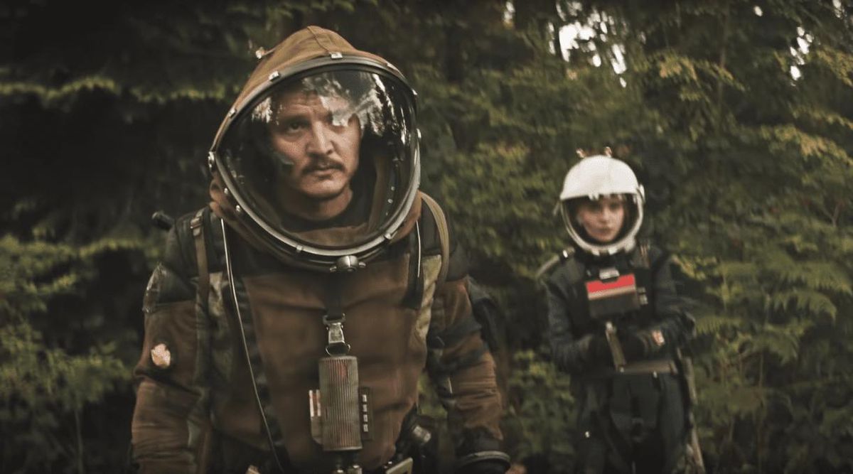 Pedro Pascal wears a space suit while walking in a forest in Prospect