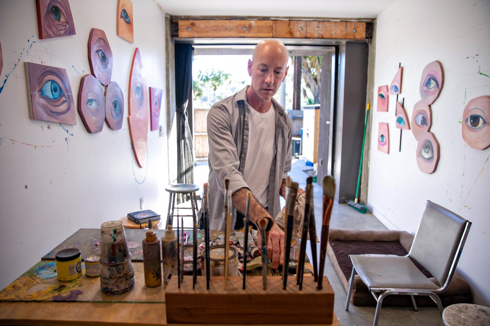 Local artist Daniel Gerwin straightens up his studio.