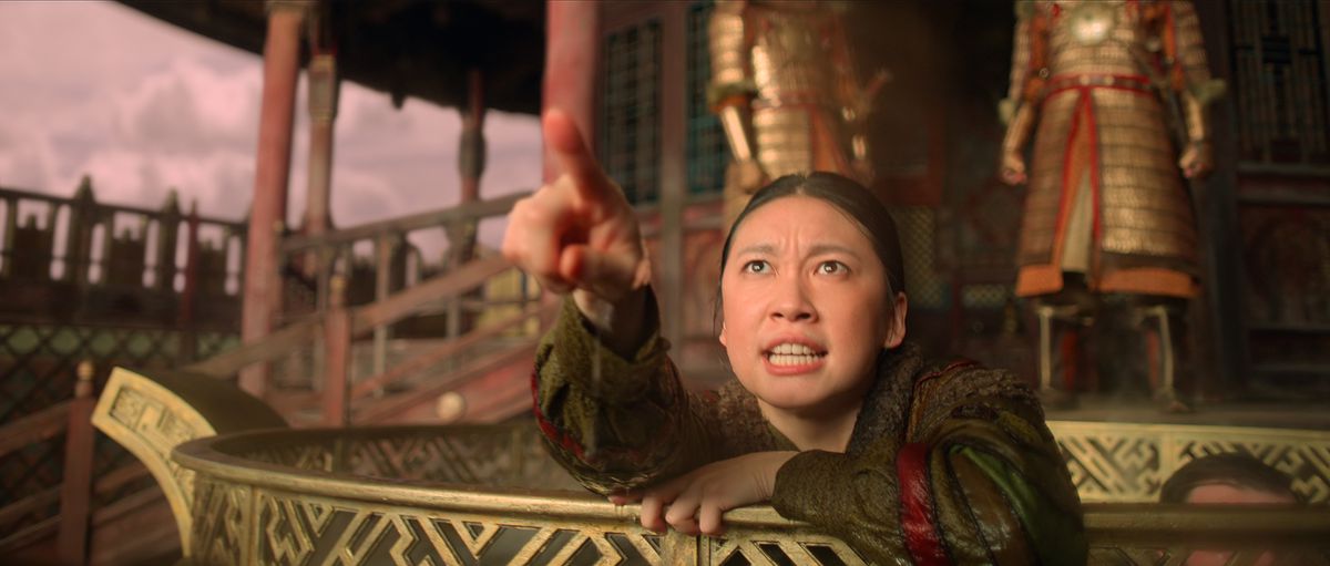 Jin Cheng (Jess Hong) pointing at an object off-screen.