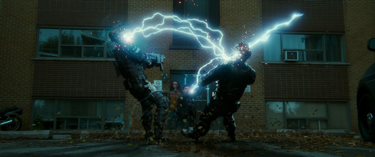 A man shoots lightning bolts out of his hands, striking two uniformed officers, in Code 8 Part II