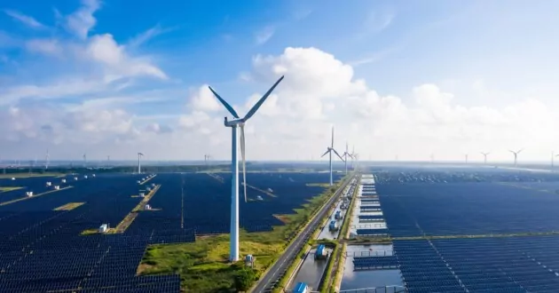 Zonne-energiecentrales met windturbines in de verte