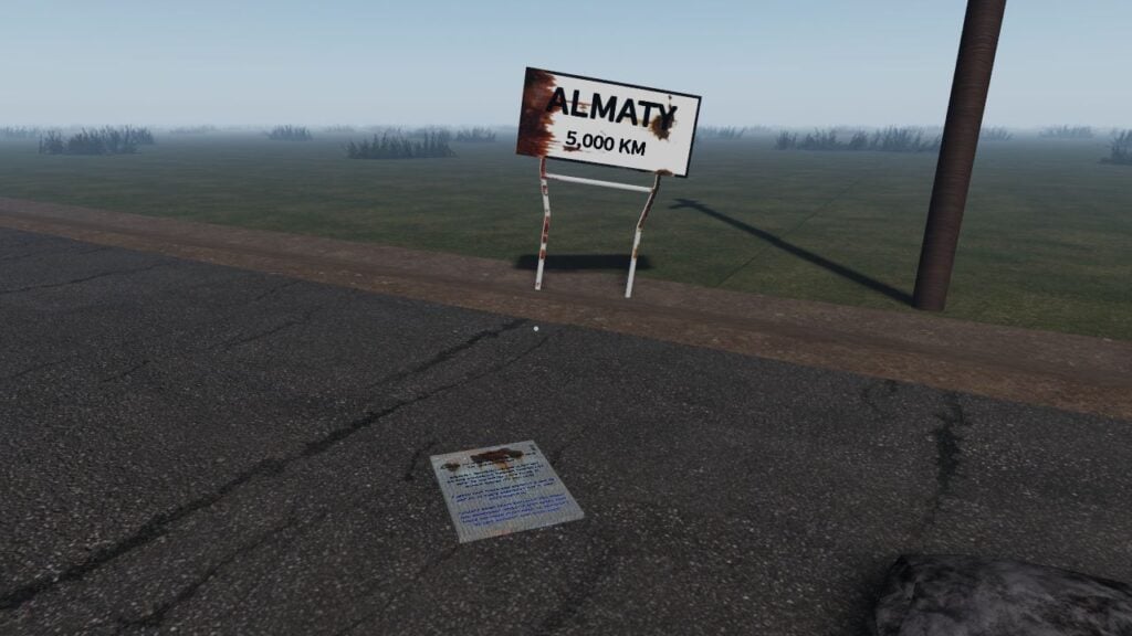 Feature image for our guide on The Long Drive Roblox how to drop items. It shows the letter item lying on a road in front of a rusting road sign.