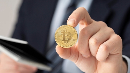 Freepik investor holding bitcoin - Canada's Proposed Mutual Fund Crypto Regulations 2024
