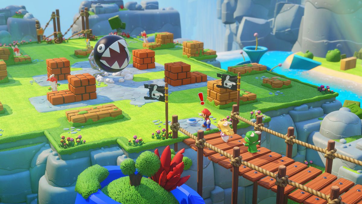 This screenshot from Mario + Rabbids Kingdom Battle shows Mario standing in front of two rabbids who are crossing a bridge. One of the rabbids is dressed as Princess Peach, and one is dressed as Luigi. Mario has an exclamation point above his head and is