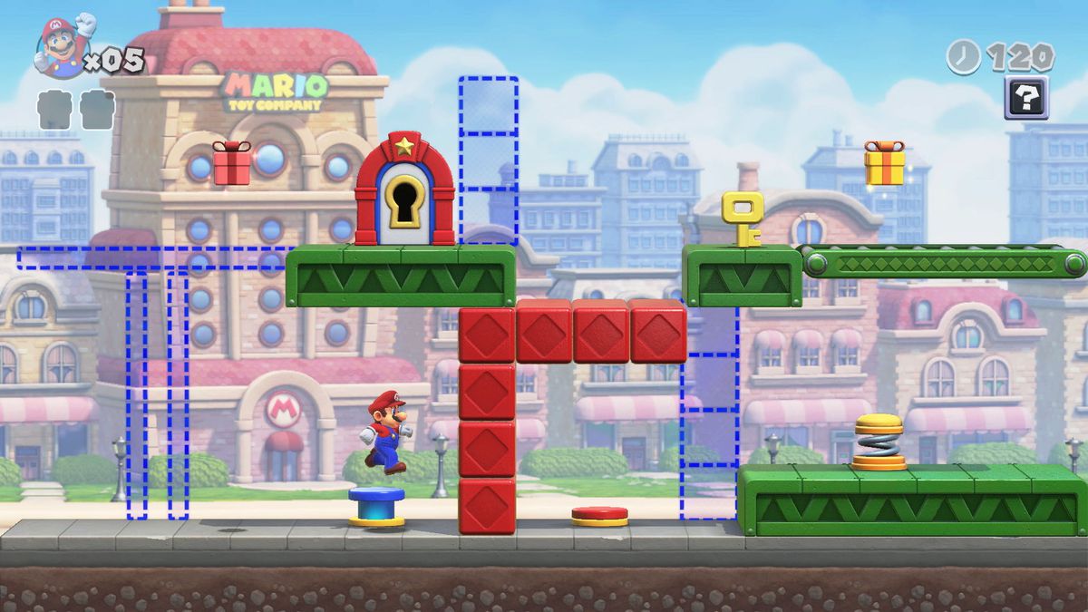 Mario jumps on a blue switch, surrounded by red and green platforms and outlines of blue ones