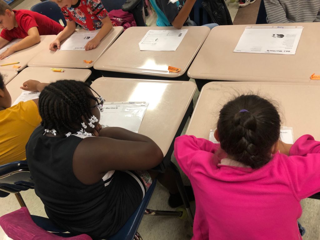 Students chorally reading flocabulary lyrics aloud together as a fluency strategy