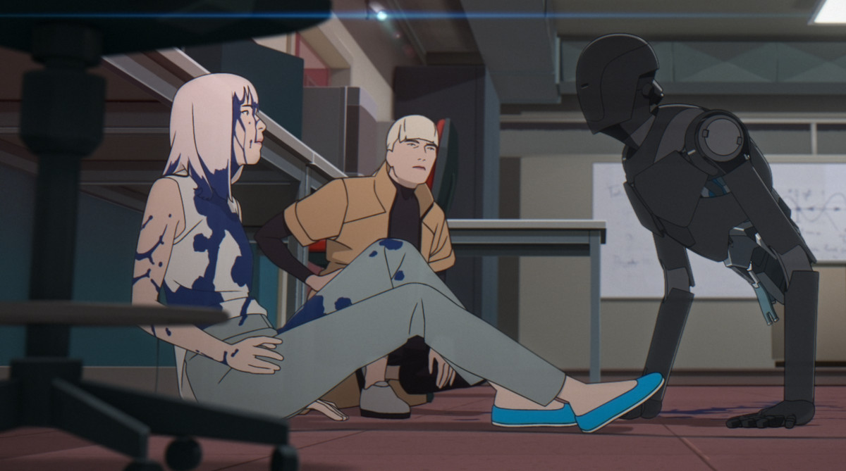 A blonde-haired woman in a yellow trench coat kneels next to a white haired woman covered in blue liquid across from a leg-less robot standing on its hands in Mars Express.
