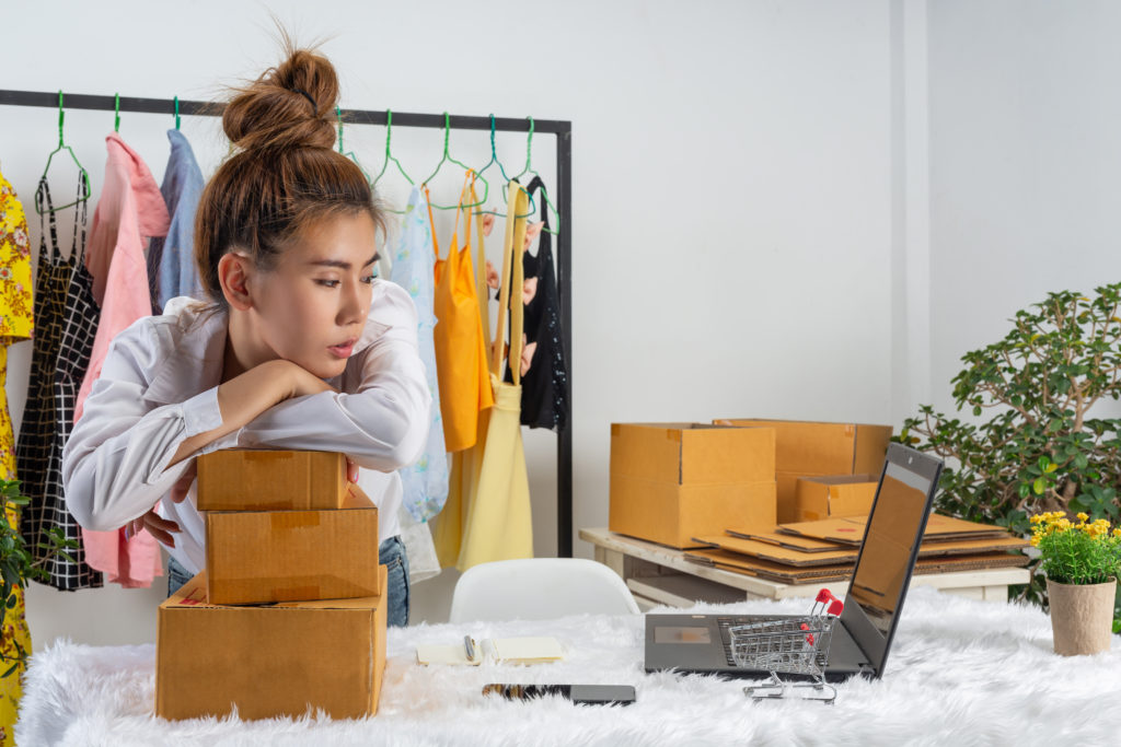 business-woman-is-working-online-traing-reply-customer-home-office-packaging-wall-scaled