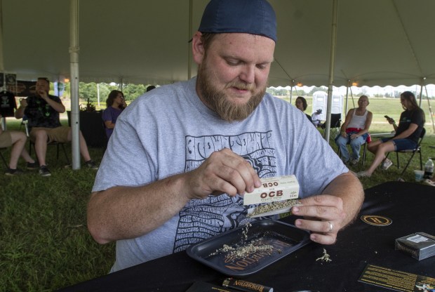 Marcus Safirt, of Michigan City, Indiana, rolls a joint during The Original Cannabis Crown at the Hartford Motor Speedway in Hartford, Michigan Friday August 27, 2022. The Original Cannabis Crown is a two-day event featuring cannabis products, live music, art and vendors. (Andy Lavalley for the Post-Tribune)