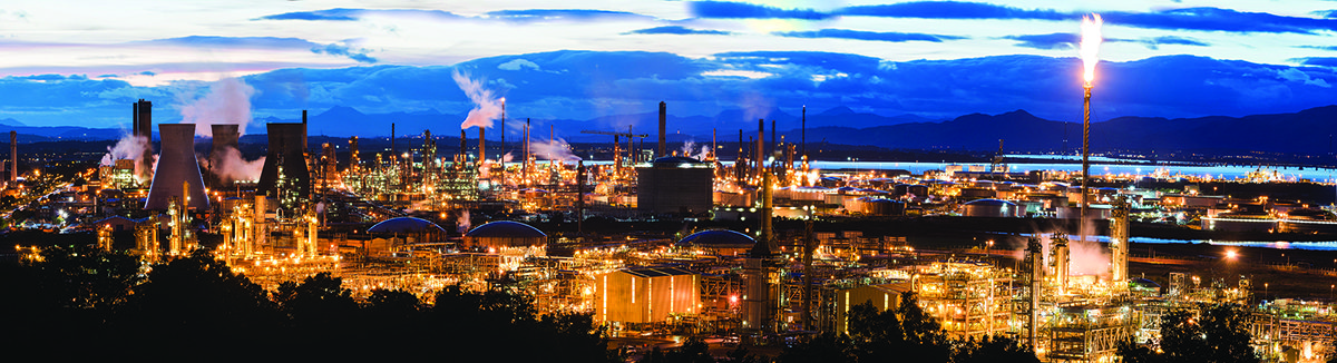 A nighttime view of Grangemouth: A light-filled skyline of oil refineries and similar buildings