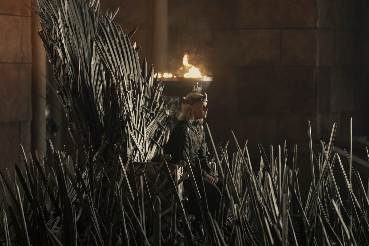 The young King Aegon sits on the Iron Throne, nearly engulfed by the swords that surround it in the season 2 premiere of House of the Dragon.