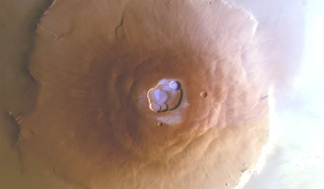 Image of Mars' Olympus Mons volcano, taken from above, shows a patch of bluish frost in an area sheltered by the volcano's caldera