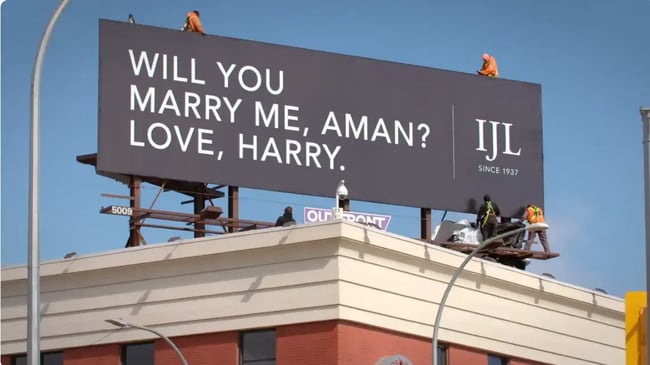 Static billboard advertising display marriage proposal.