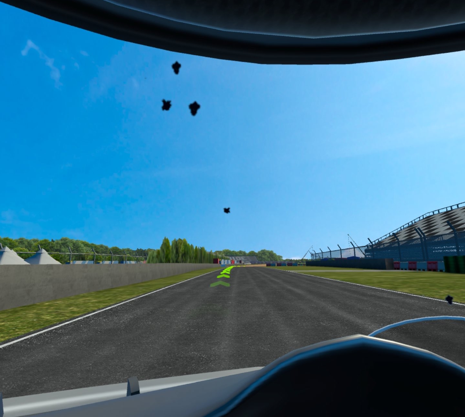 VRIDER screenshot - A dirty visor with dirt across the space. Beyond this is an open road for racing.